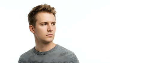 Caucasian male, approximately 25-35 years old, with light brown hair, wearing a gray crew neck sweater against white background. Suitable for business, lifestyle, and portrait projects.