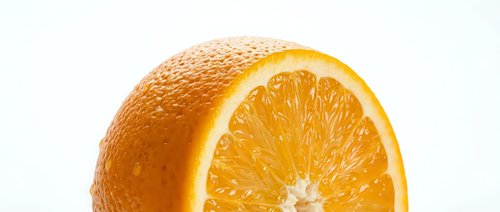 Whole orange fruit with fresh cut slice showing juicy citrus segments and vibrant yellow flesh against white background for food and beverage design.