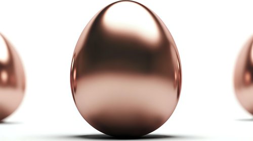 Shiny rose gold metallic eggs on white background for luxury Easter decoration and premium holiday design projects.