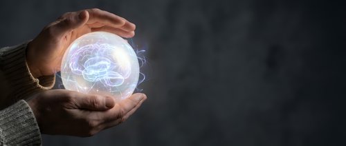 Hands protecting glowing brain hologram representing mental health, neuroscience research, artificial intelligence and cognitive protection concepts.