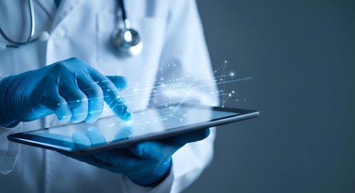 Healthcare professional using digital tablet with futuristic interface technology for medical data analysis and patient care management in modern clinic.