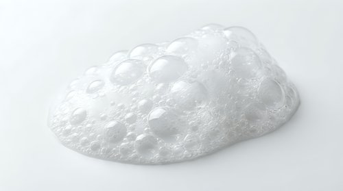 White foam soap bubble texture isolated on clean background for skincare and beauty product design applications.