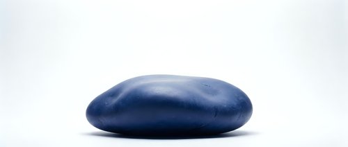Smooth blue oval stone or pebble isolated on white background for zen meditation, spa wellness, balance and natural decoration concepts.