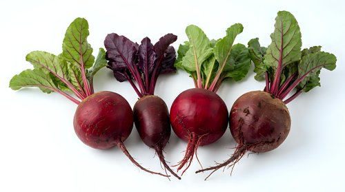 Fresh organic beetroot with green leaves isolated on white background for healthy cooking and nutrition concepts.