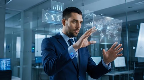 Professional businessman in navy suit interacting with futuristic holographic interface displaying global data analytics and charts in modern office.