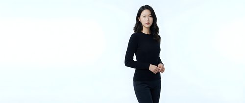 Young Asian businesswoman in black dress standing confidently on white background, isolated for professional corporate design projects.