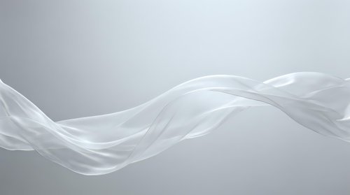 Flowing white silk fabric waves across neutral gray background, creating elegant abstract motion and smooth curves for modern design projects.