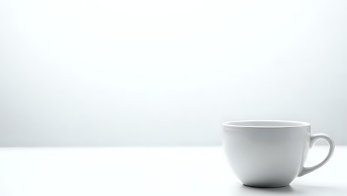 White ceramic coffee cup on clean surface against minimalist background for morning beverage concepts and kitchen design projects.