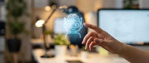 Human hand touching glowing brain hologram with circuit patterns in modern office workspace representing artificial intelligence and machine learning technology.