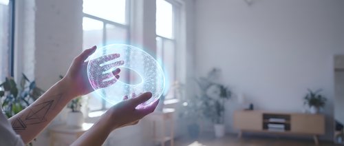 Hands holding futuristic holographic globe with data visualization in modern office space for technology and innovation concepts.
