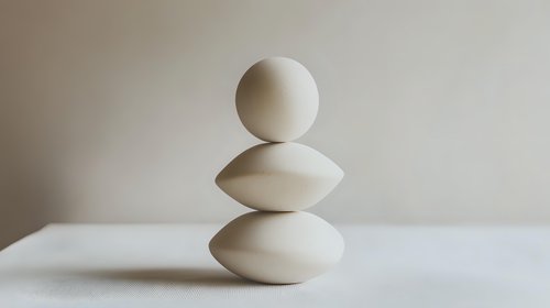 Minimalist balanced white stones composition on light background creates zen atmosphere and represents harmony, balance, and meditation concept for wellness design.