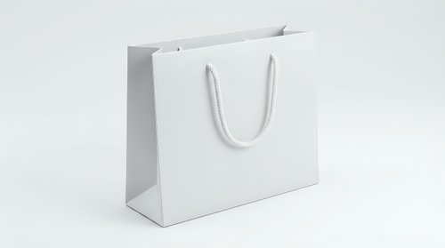 White paper shopping bag with rope handles isolated on light background for retail branding and commercial design projects.