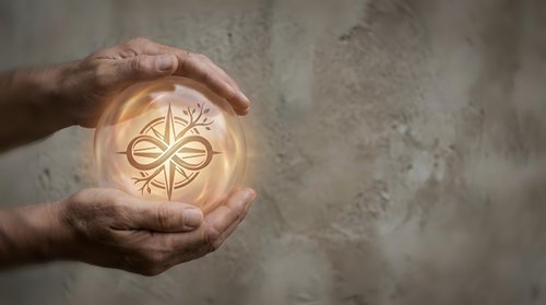 Protective hands cupping glowing compass symbol representing guidance, direction and navigation in business planning and life decisions.