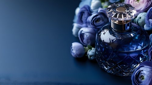 Luxury crystal perfume bottle with purple roses and pearls on dark blue background for elegant beauty and fragrance advertising campaigns.