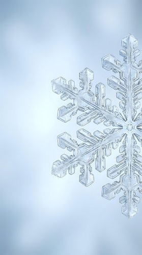 Macro close-up of intricate snowflake crystal showing detailed hexagonal structure and delicate ice formations against soft blue winter background.