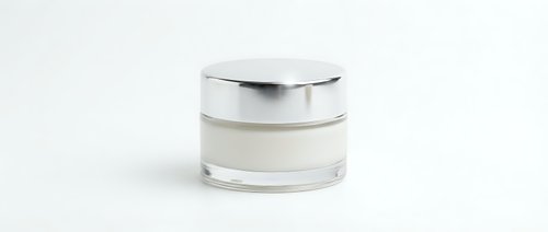 Luxury cosmetic cream jar with silver cap isolated on white background for skincare and beauty product packaging design.