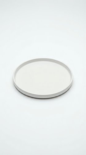 Empty white ceramic plate isolated on white background for food presentation and kitchen design projects.