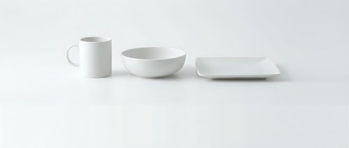 White ceramic dinnerware set with mug, bowl and plate on clean background for kitchen and dining room decor, tableware collection for modern home.
