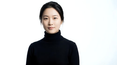 Professional Asian woman in black turtleneck sweater against white background, confident business portrait for corporate marketing materials.