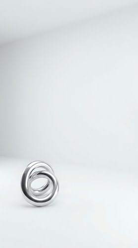 Modern silver metallic spiral ring sculpture on white background with copy space for contemporary design projects.