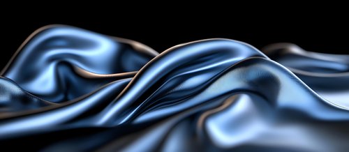 Luxurious dark blue silk fabric with smooth waves and gentle folds creates dramatic light effects against black background, showcasing elegant textile movement.