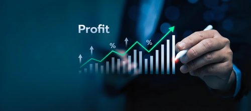Businessman hand drawing profit growth chart with upward trending arrows and percentage symbols on dark blue background for financial success presentation.