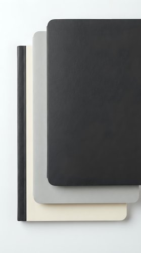 Three stacked softcover notebooks in black, gray, and cream on a white background, minimalist stationery set for office, journaling, and planning.