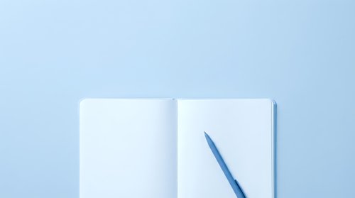 Young professional woman with medium skin tone writing in open notebook with blue pen on light blue background, suitable for business, education, planning, and productivity concepts.