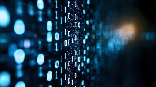 Digital binary code stream on dark background with glowing blue numbers and bokeh effect, representing data flow and cyber technology concept.