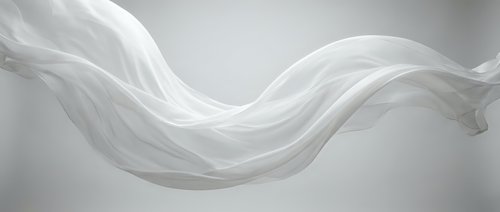 Flowing white silk fabric with elegant curves and soft shadows creating graceful movement against neutral background for luxury design projects.
