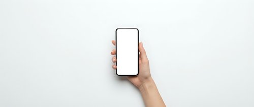 Hand holding modern smartphone with blank white screen mockup against light gray background for app presentation and digital marketing materials.