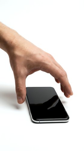 Male hand with light skin tone reaching toward smartphone with black screen on white background, isolated for app design and technology marketing use.