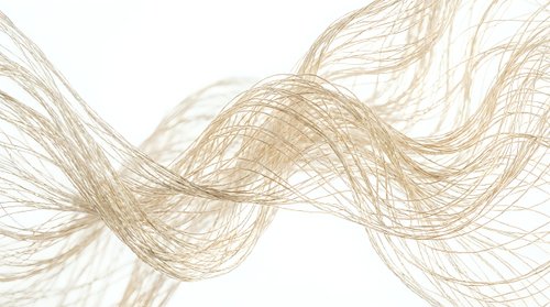 Abstract golden flowing lines creating dynamic wave pattern on white background for modern design projects and digital art applications.