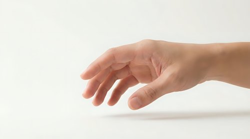 Human hand reaching forward with fingers slightly curved in gentle grasping gesture against clean white background for design projects.
