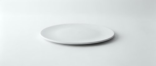 Empty white ceramic plate on clean white background isolated for kitchen dining and food presentation mockup design.