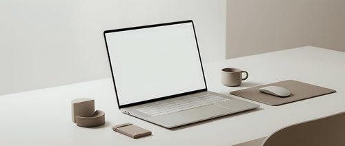Modern minimalist workspace with open laptop displaying blank white screen on clean desk setup for productivity and remote work presentations.
