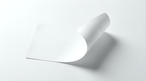 Curved white paper sheet with elegant fold creating dynamic shadow on clean background for modern design projects and presentations.