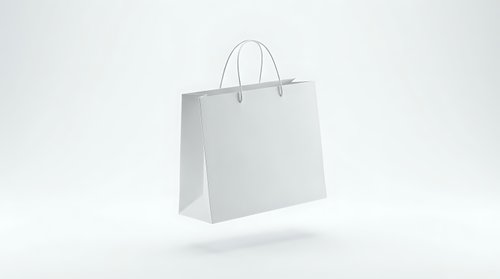 White paper shopping bag with handles isolated on light background for retail branding and commercial design projects.