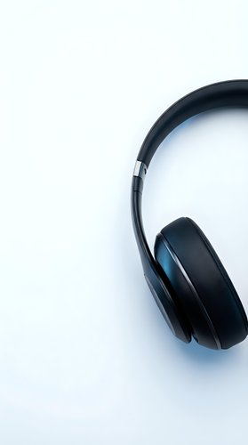 Modern black wireless headphones on clean white background for music streaming and audio technology concepts.