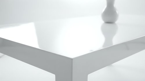 Modern white glossy table corner with minimalist design and clean reflective surface for contemporary interior decoration and furniture concepts.