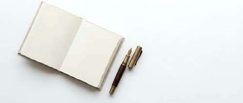 Open blank notebook with two pens on white background, suitable for business planning, journaling, writing, education, and creative projects.