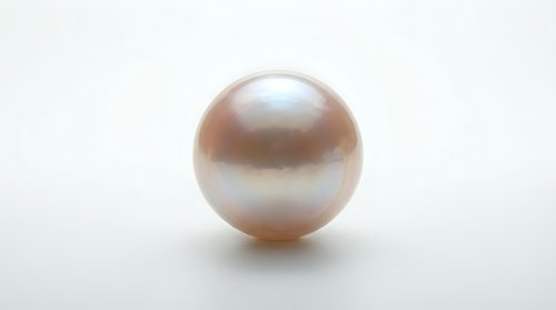 Lustrous pearl sphere with soft peachy-pink iridescent finish isolated on white background, suitable for jewelry, luxury, cosmetics, and design projects.