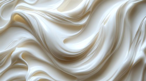 Smooth flowing cream silk fabric with elegant waves and soft folds creating luxurious textile background for fashion and interior design projects.