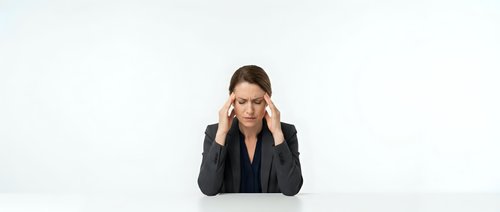 Professional businesswoman experiencing headache stress at workplace holding temples with hands isolated on white background for corporate wellness concepts.