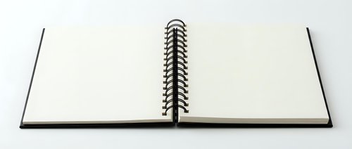 Open spiral-bound notebook with blank white pages on neutral background, ready for writing, sketching, journaling, or creative projects and design work.