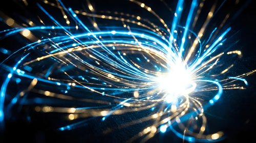 Dynamic energy burst with flowing blue light trails and bright central core creating futuristic abstract motion effect for technology and science concepts.