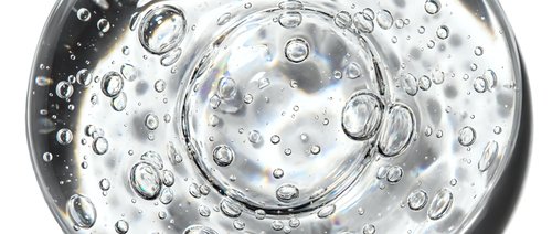 Transparent water droplets and bubbles floating in clear liquid, isolated on white background for design and advertising use.
