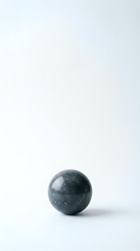 Dark green marble sphere on white background with soft shadow for minimalist design projects and wellness concepts.