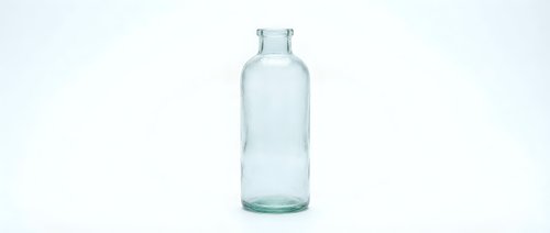 Empty clear glass bottle isolated on white background for product packaging design and branding projects.