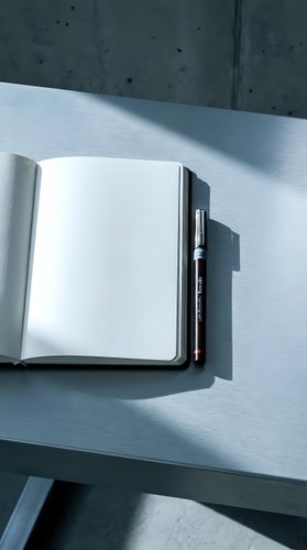 Open notebook with blank pages and pen on light surface with concrete wall background, suitable for business planning, education, writing projects, and creative work concepts.